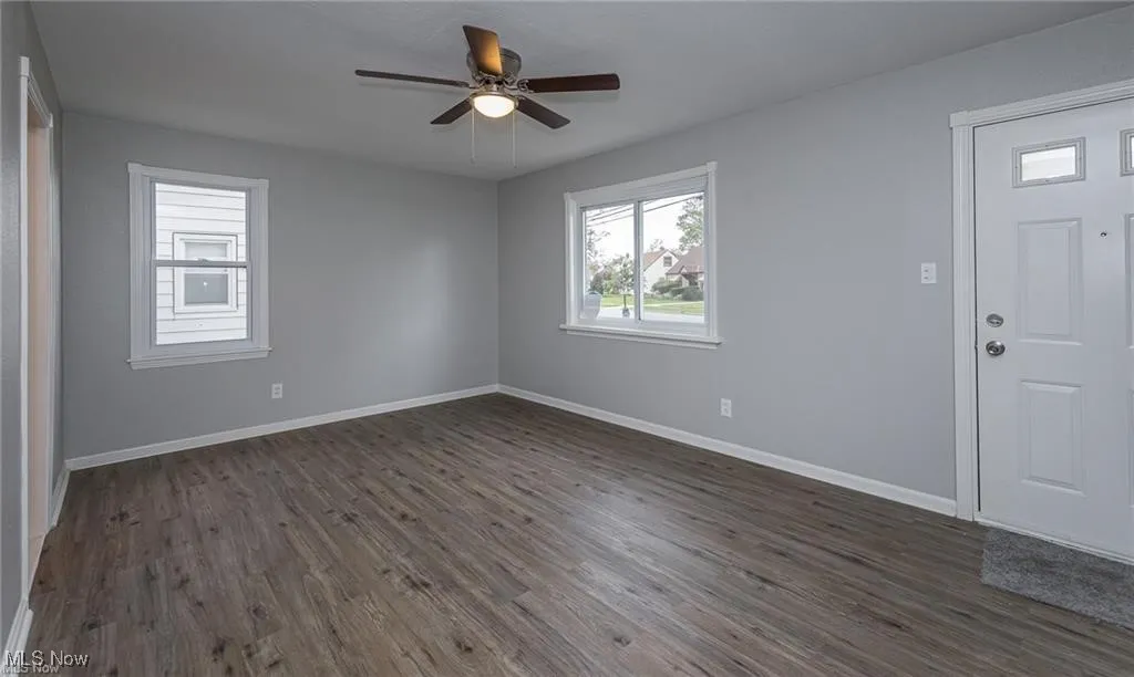 Entrance foyer featuring dark wood-type flooring and ceiling fan