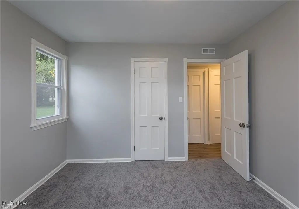 Unfurnished bedroom featuring carpet floors and baseboards