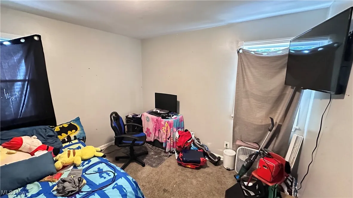 Unfurnished bedroom with carpet flooring and baseboards