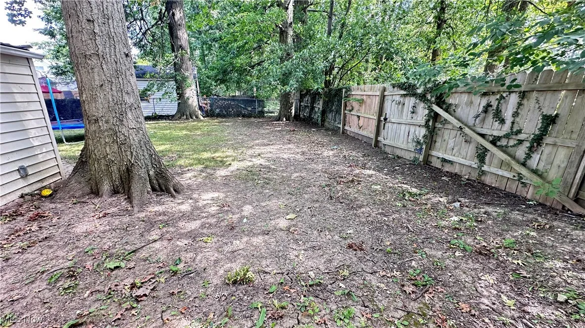 Fenced backyard with a trampoline