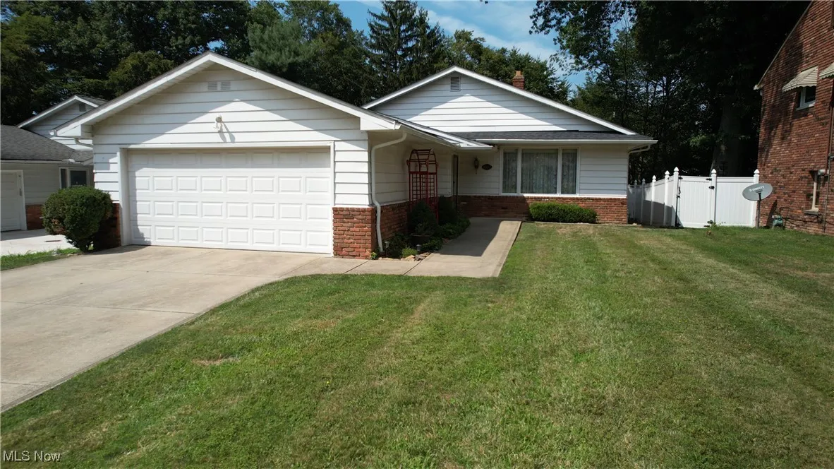 Ranch-style house with brick siding, concrete driveway and an attached 2 car garage