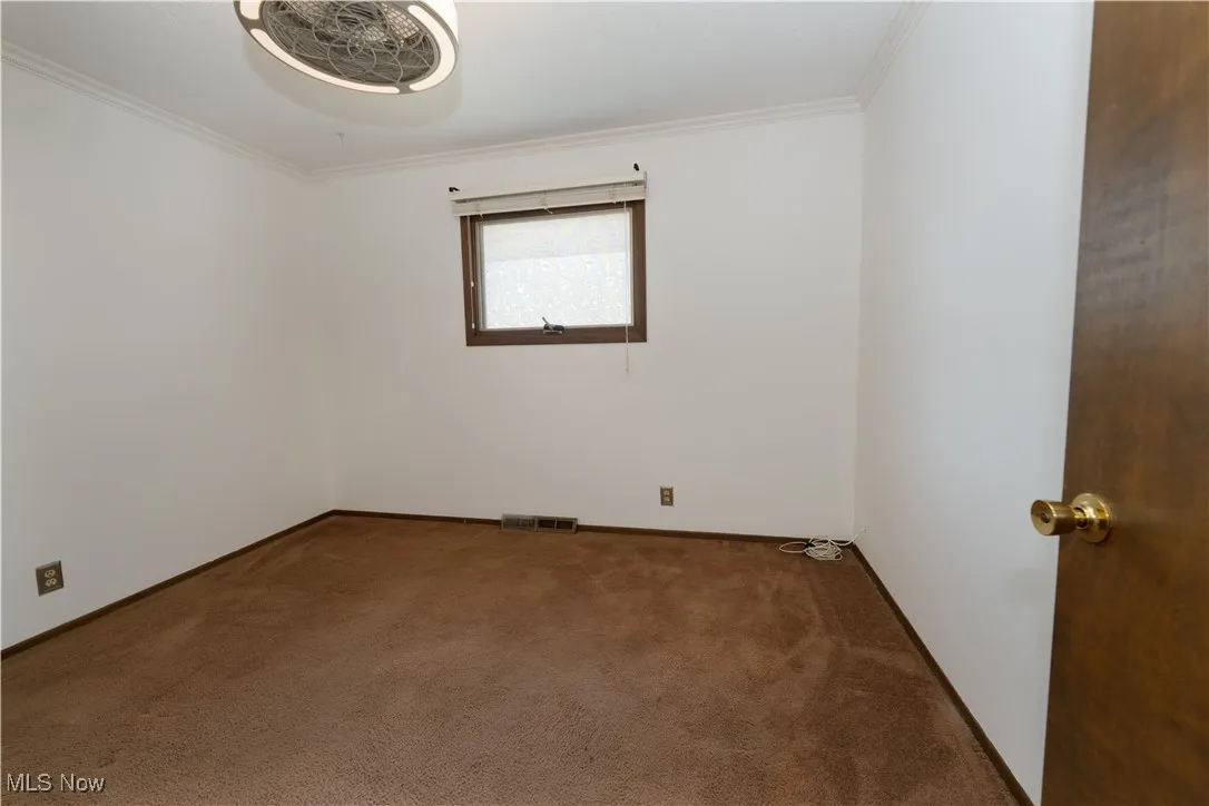 2nd Bedroom with crown molding and carpet flooring