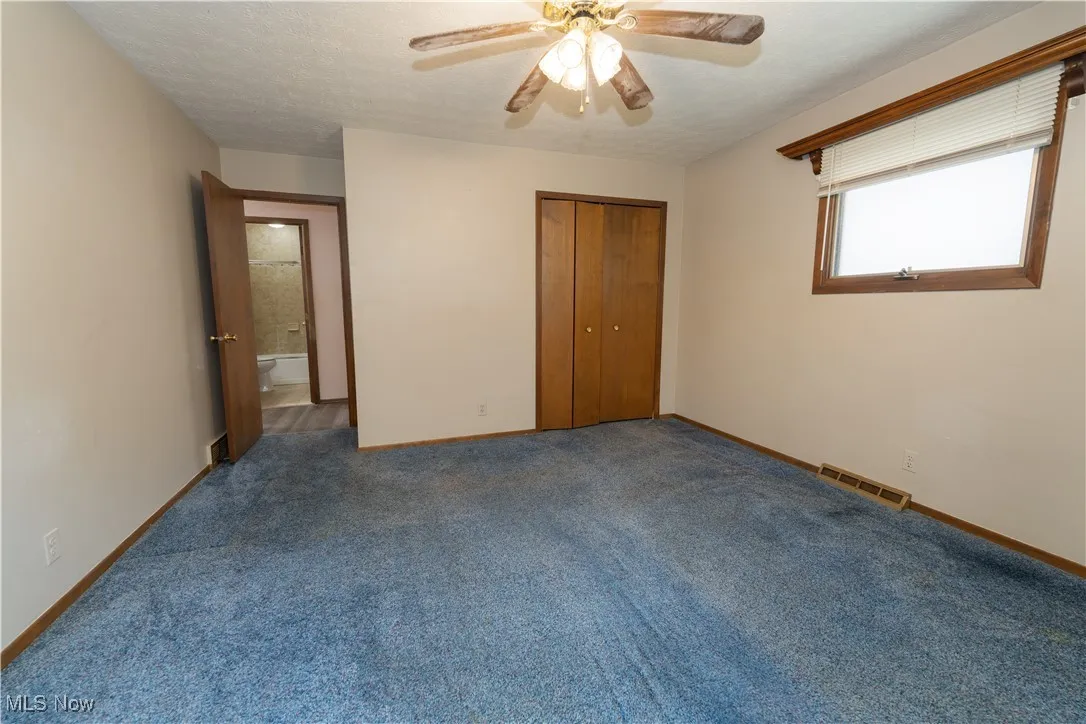 3rd bedroom with carpet flooring, a large closet and ceiling fan