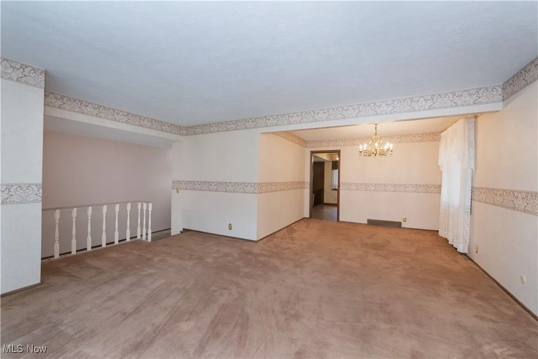Living room layout view showing open concept to dining room and walk way to kitchen