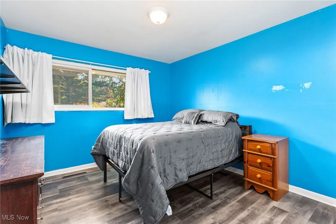 Bedroom with laminate flooring.