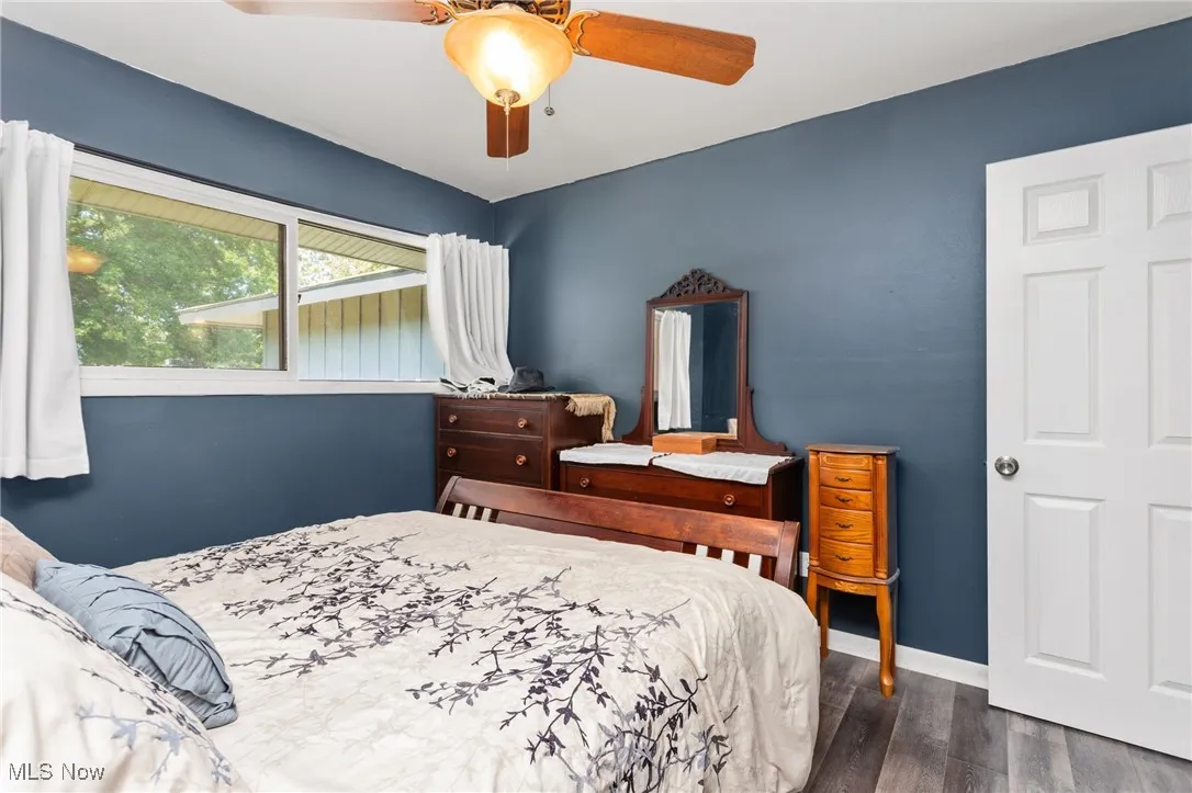 Bedroom with laminate floors and a ceiling fan