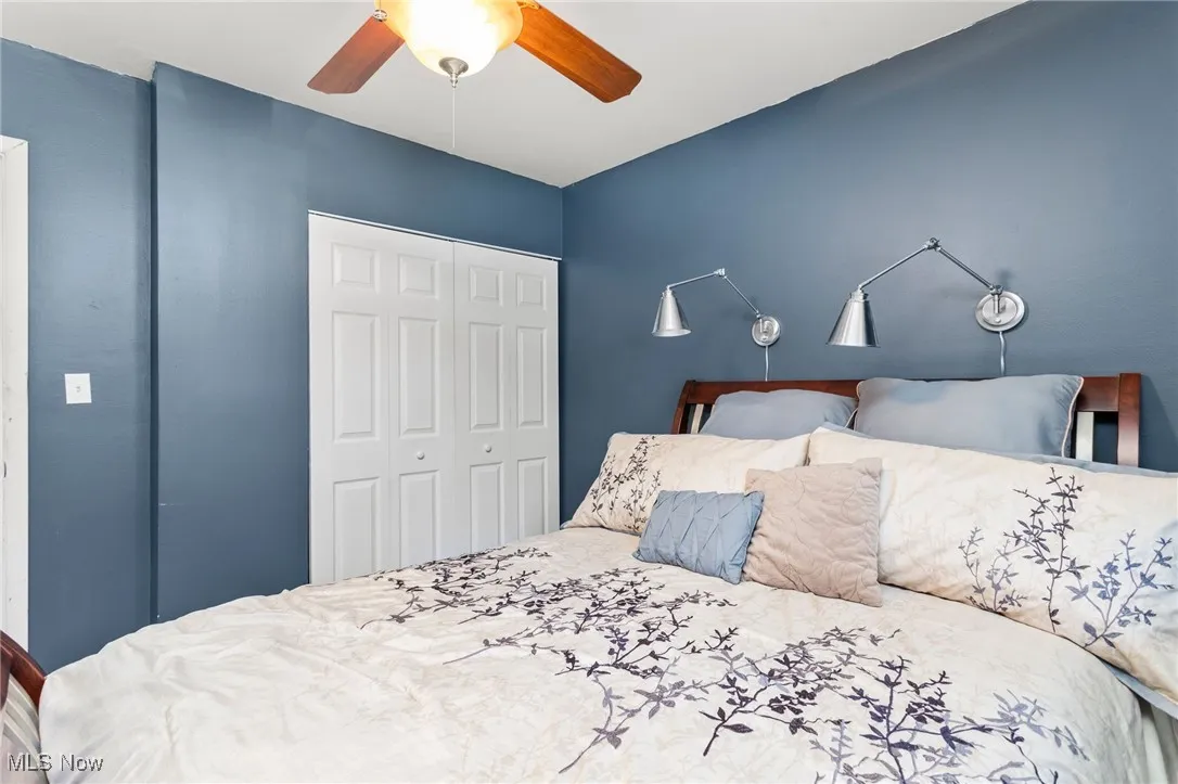 Bedroom with laminate floors and a ceiling fan