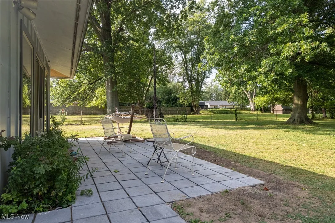 Fenced backyard with a new patio area.