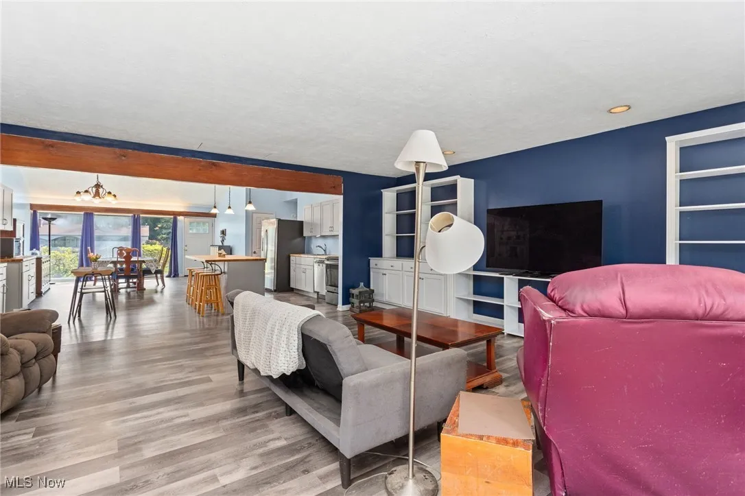 Living area featuring laminate flooring open to kitchen