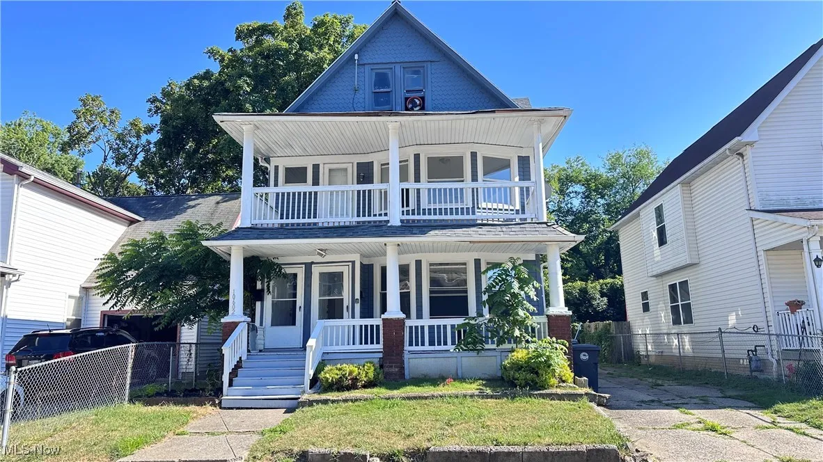 View of front of property with covered porch and a balcony
