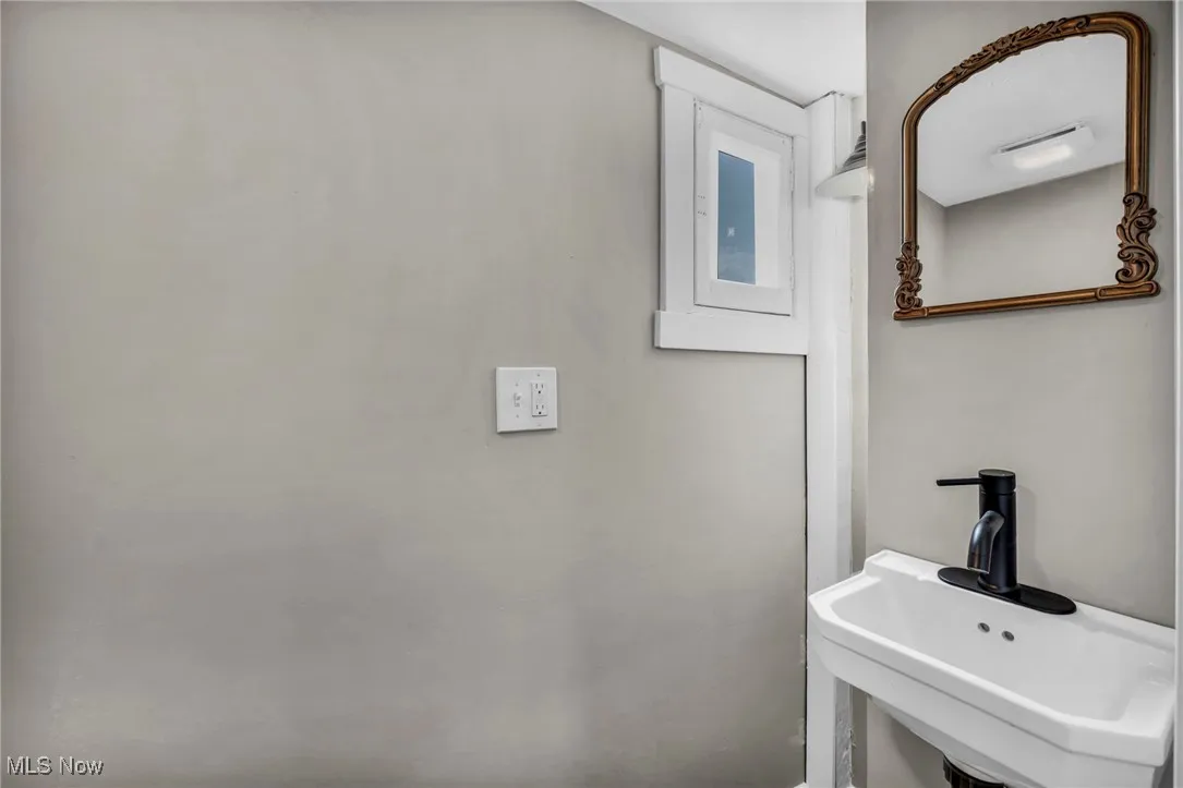 Half Bathroom featuring a sink.