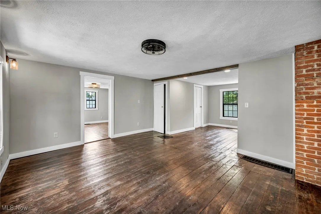 Unfurnished living room with hardwood / wood-style flooring.