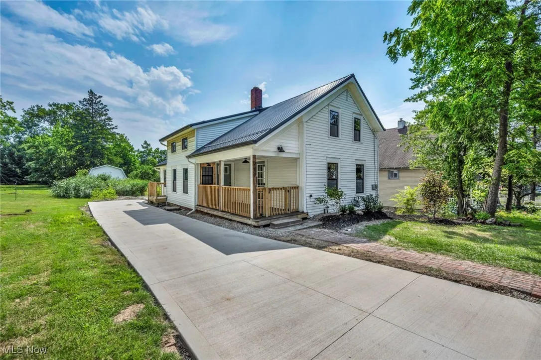 View of side of home featuring covered porch.