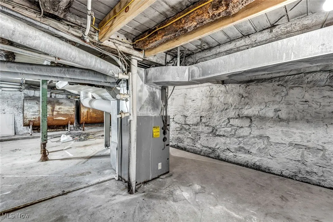 Unfinished below grade area with heating unit