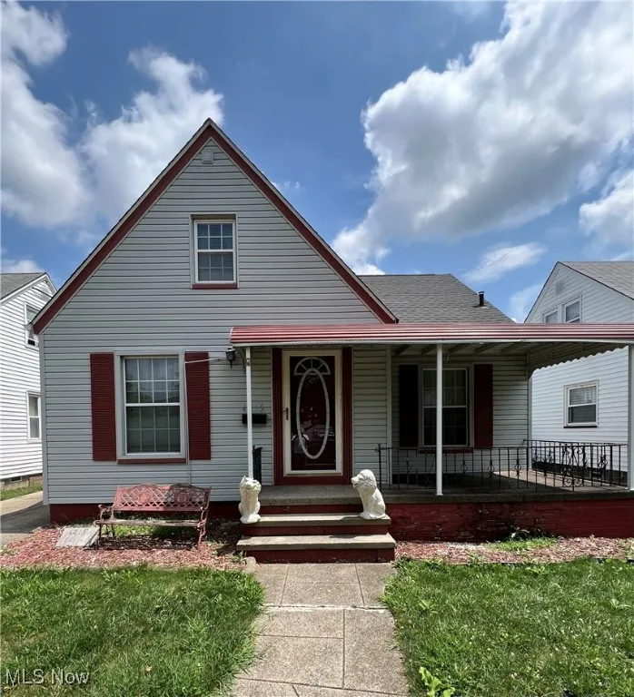 Cape Cod-style house featuring a porch and a front​​‌​​​​‌​​‌‌​‌‌​​​‌‌​‌​‌​‌​​​‌​​ yard