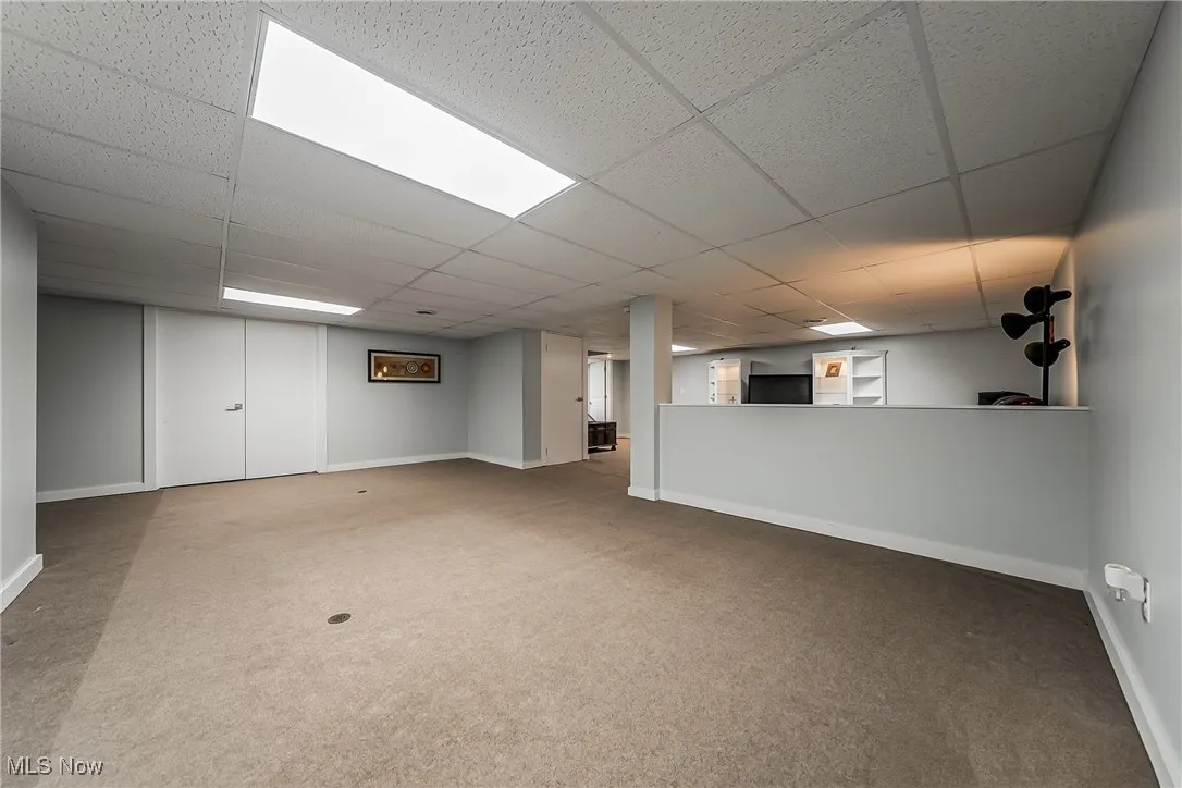 Finished basement area is great place to add a foosball, pool table and dining area or play area.  Doors in this space lead to a large storage area and houses hotwater tank and furnace with room to spare.