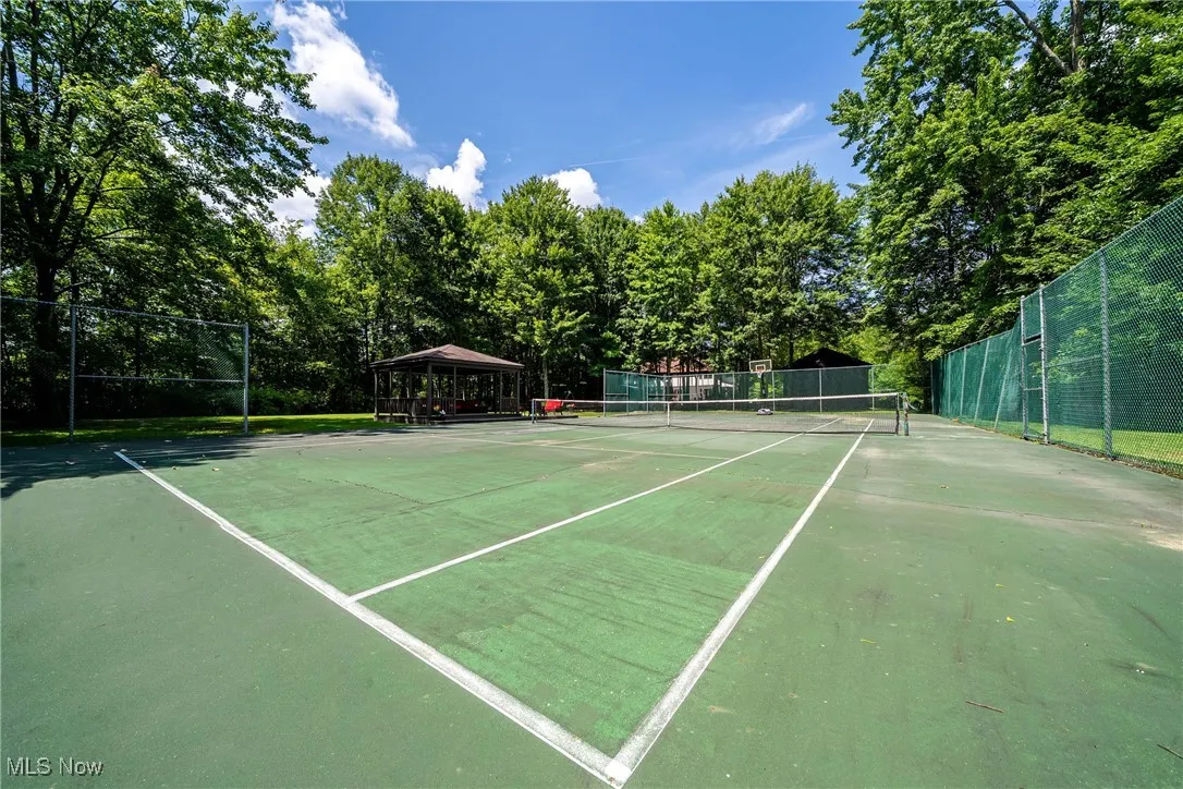 View of tennis court which can be also converted to pickball court(s) or a full size basketball court or even a area for tikes to ride on toys!