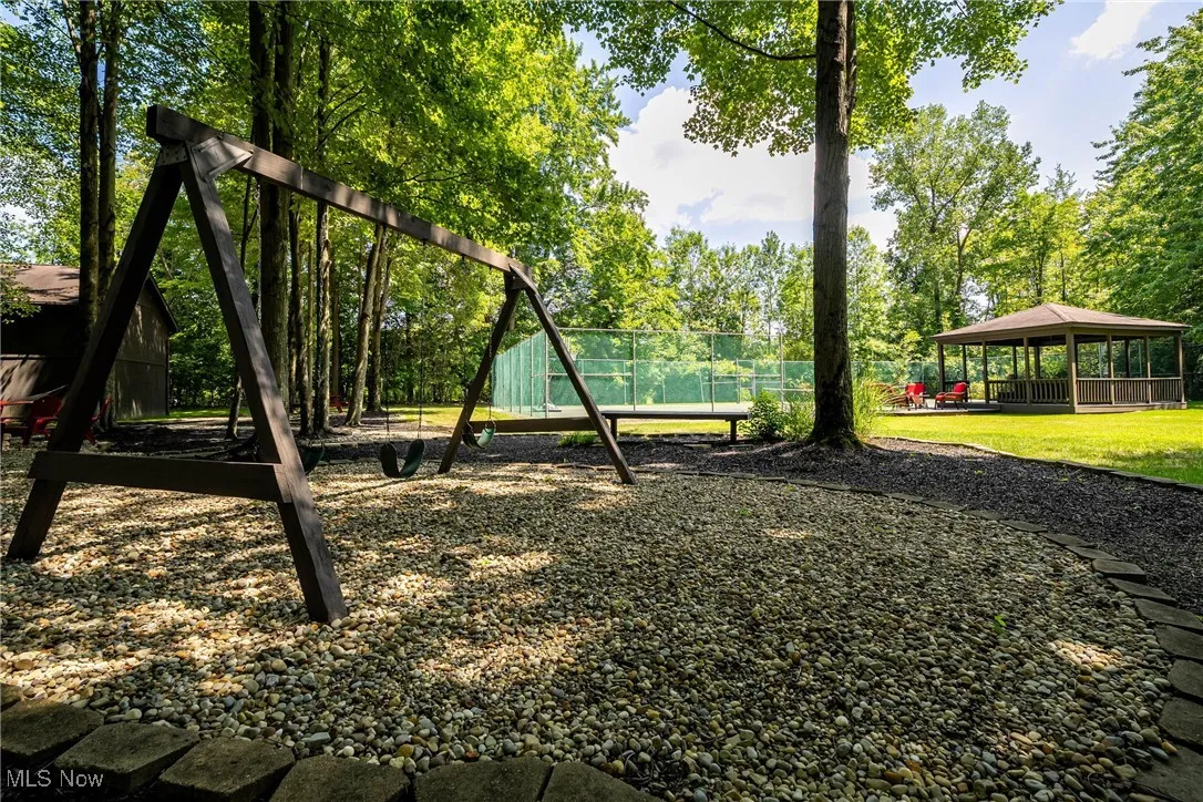 View of jungle gym and deck #3 with a gazebo