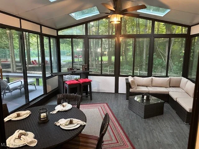 Sunroom / 3 season rm with lofted ceiling, skylights andfeaturing LTV floors, has gorgeous views to the park-like backyard.