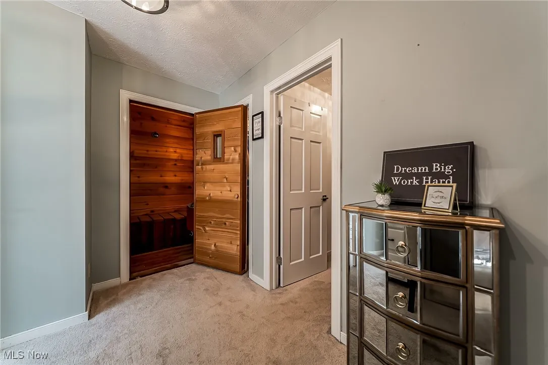 Dressing area with 2 walk in closests, vanity, and a sauna / steam room