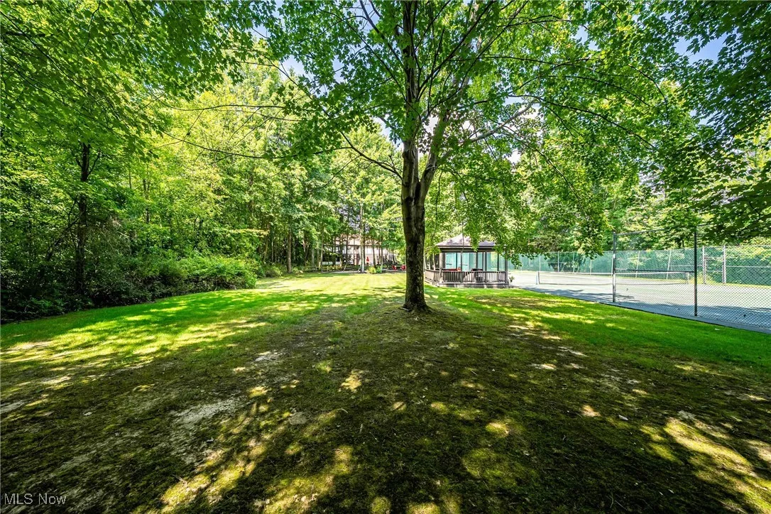 View of yard featuring a tennis court and a gazebo