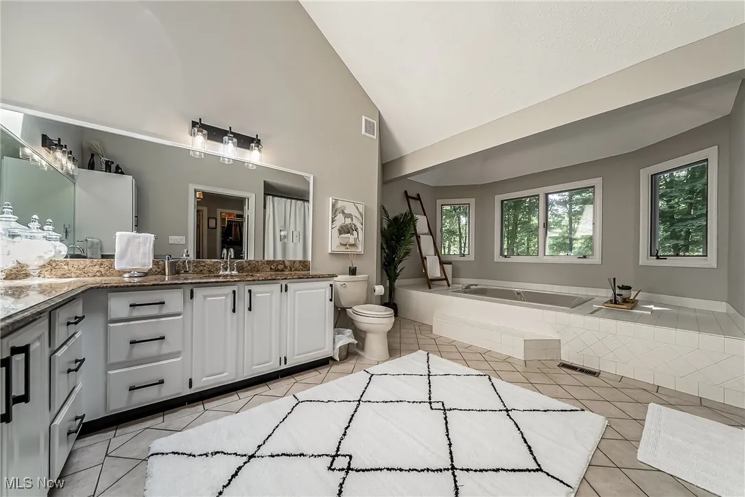 Primary bath has separate shower and whirlpool tub