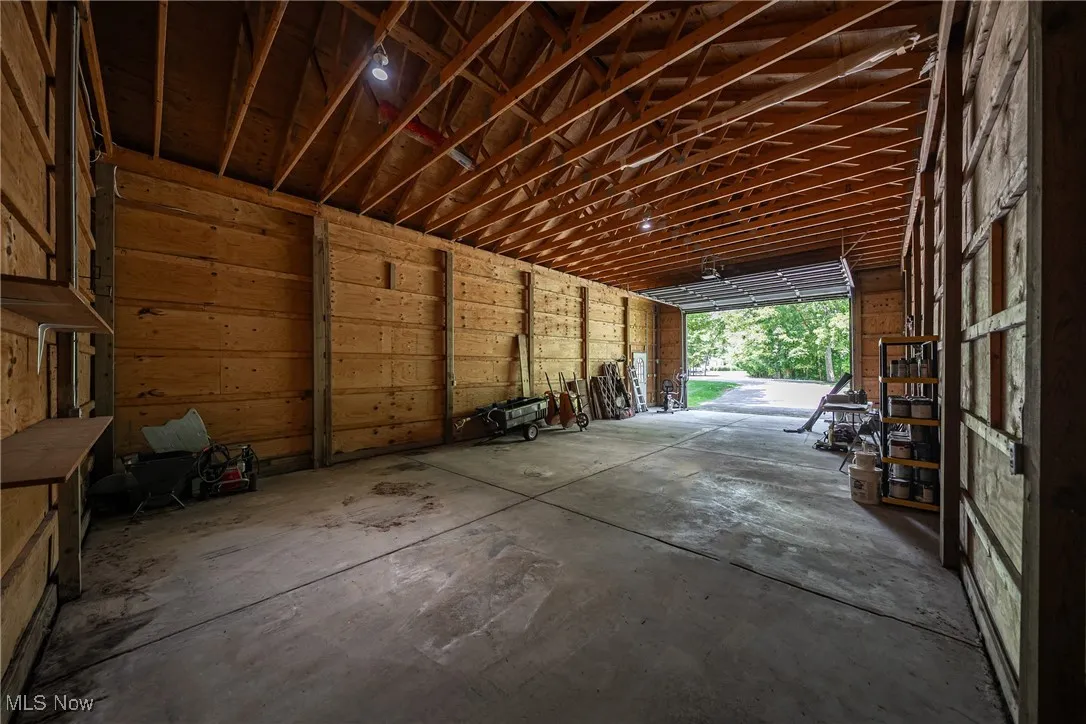 with unfinished concrete flooring and a garage could also be used a workshop