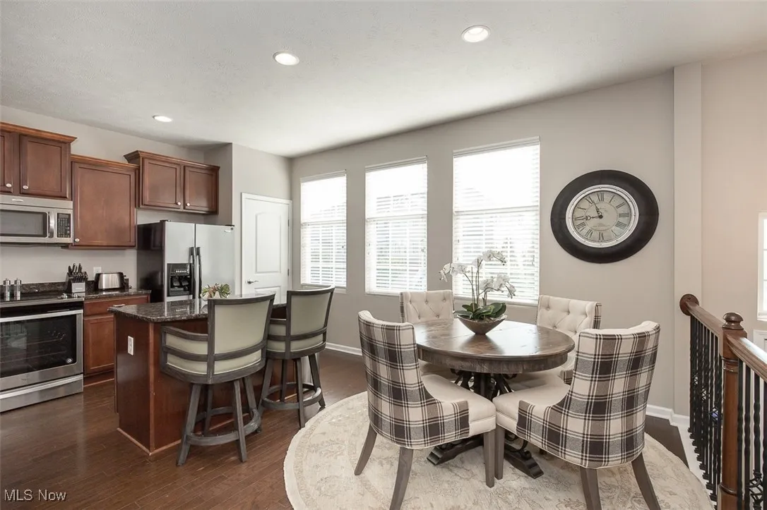 Dining space featuring plenty of natural light, recessed lighting, and dark wood-style flooring