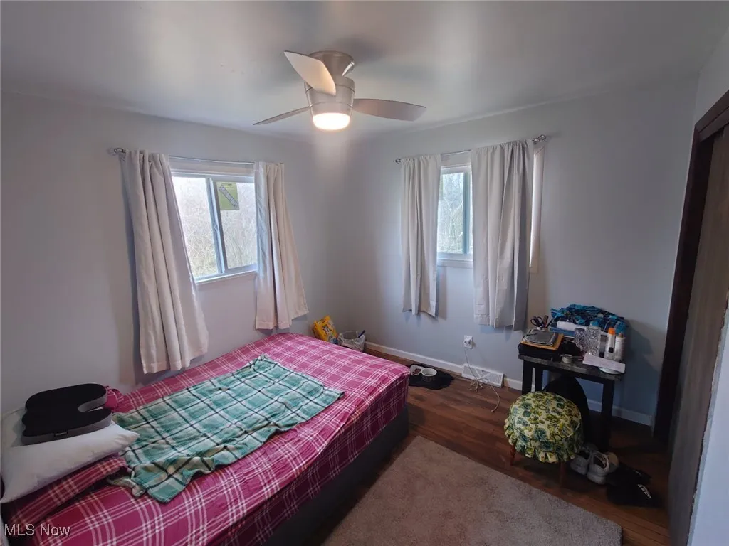 Bedroom with wood finished floors and a ceiling fan