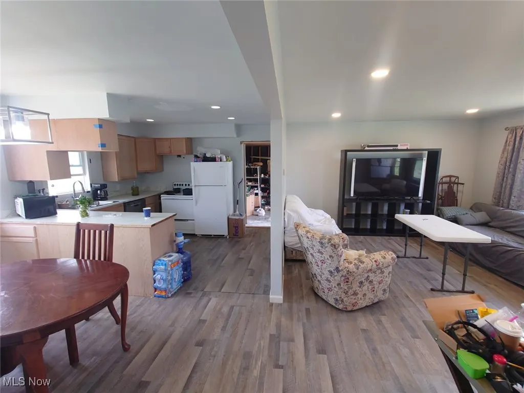 Living area featuring dark wood-style flooring and recessed lighting