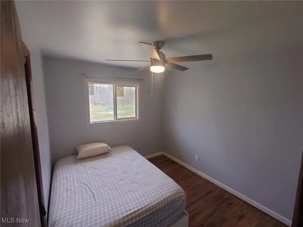 Bedroom featuring dark wood-style flooring and ceiling fan