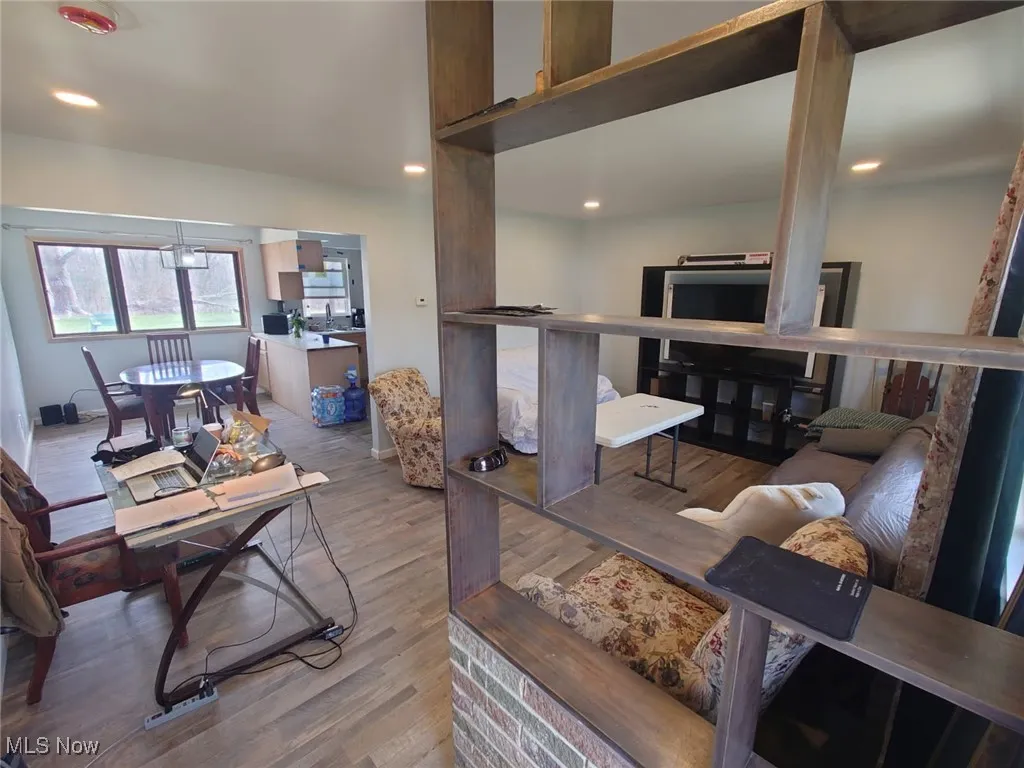 Living area with wood finished floors and recessed lighting