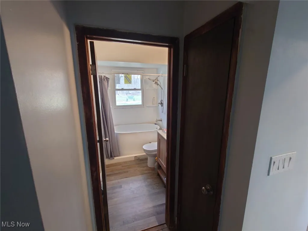 Corridor featuring light wood finished floors