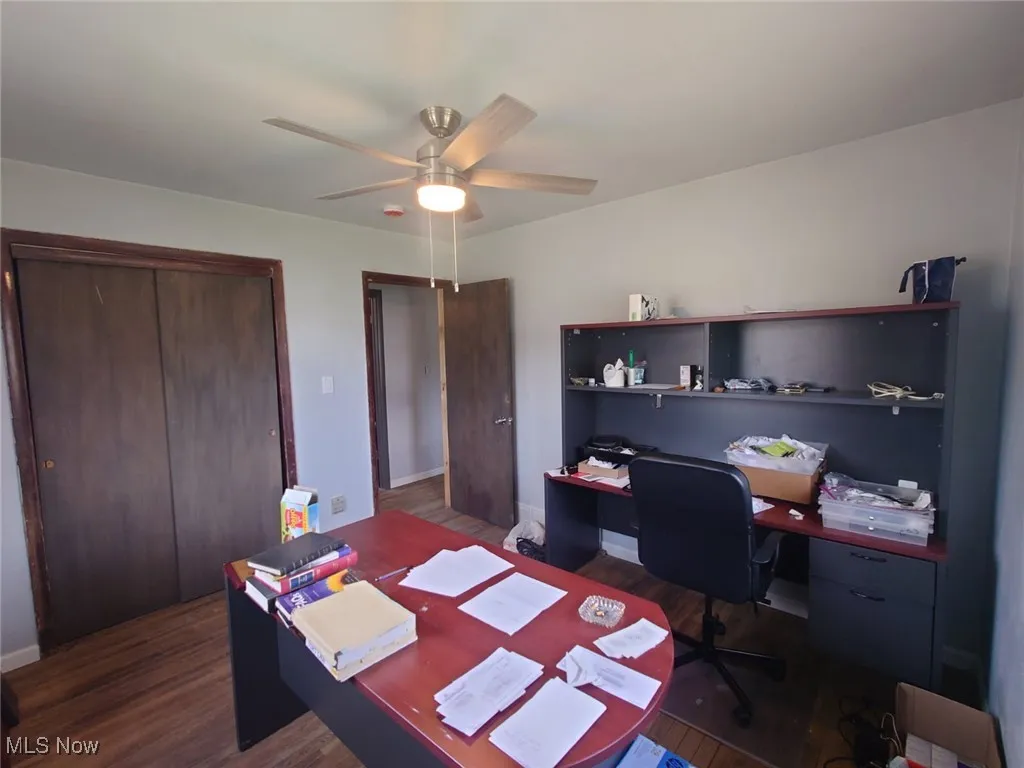 Office featuring dark wood-style flooring and ceiling fan