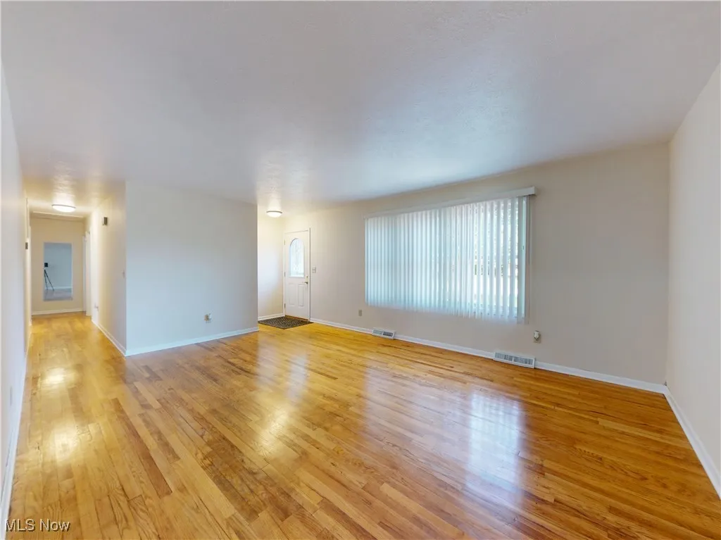 Unfurnished room featuring light wood-style flooring and baseboards