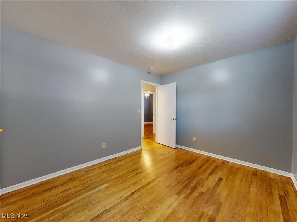 Spare room featuring a textured ceiling and light wood-style flooring