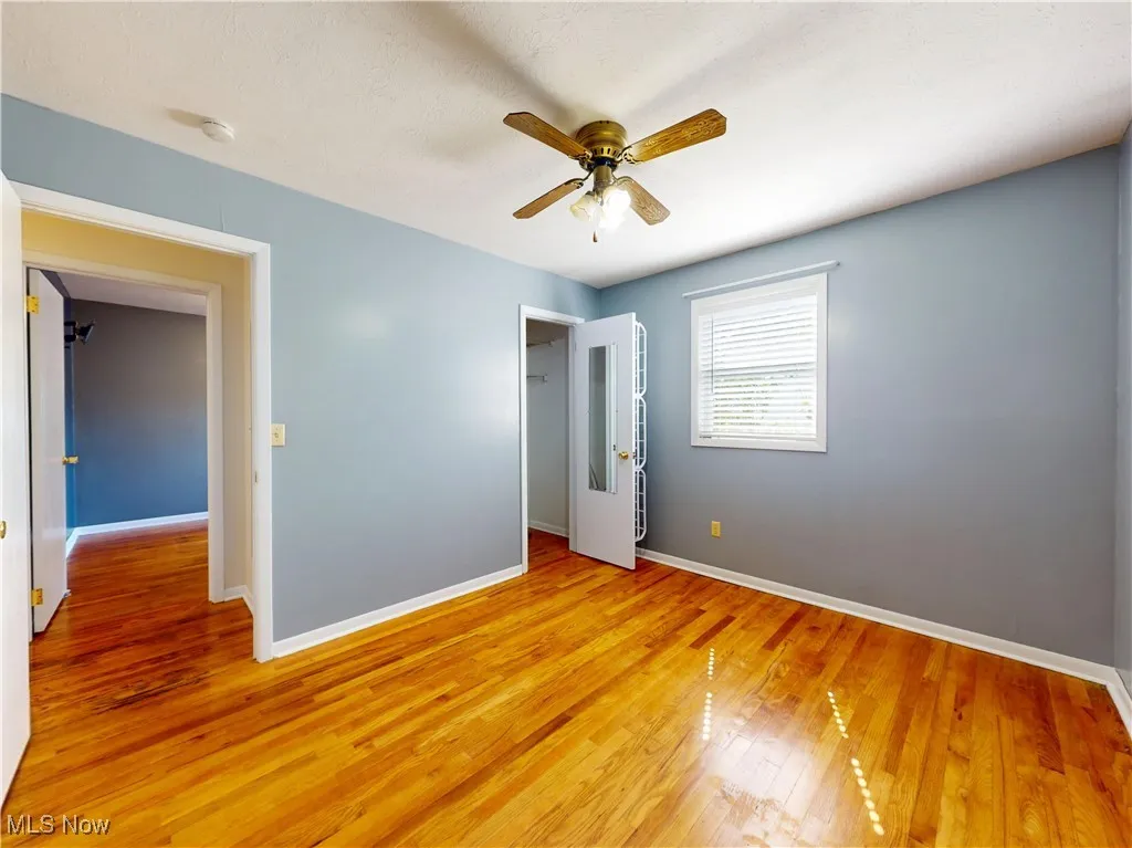 Unfurnished bedroom with light wood-style flooring and ceiling fan