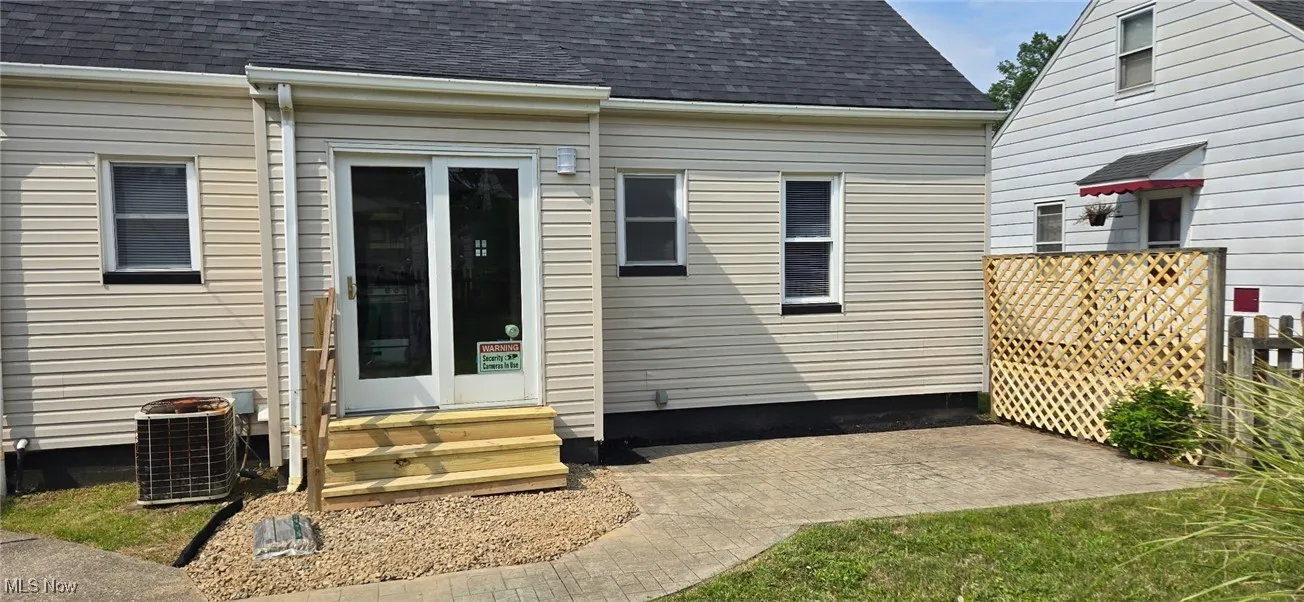 Property entrance with roof with shingles