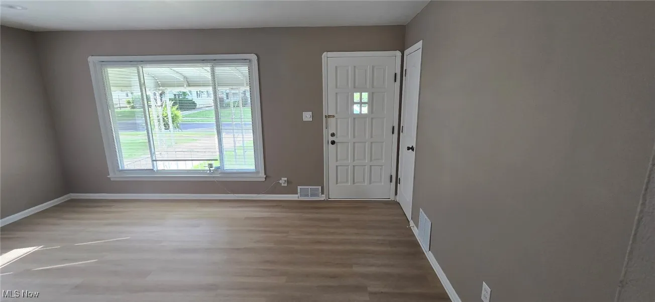 Foyer featuring baseboards and light wood finished floors