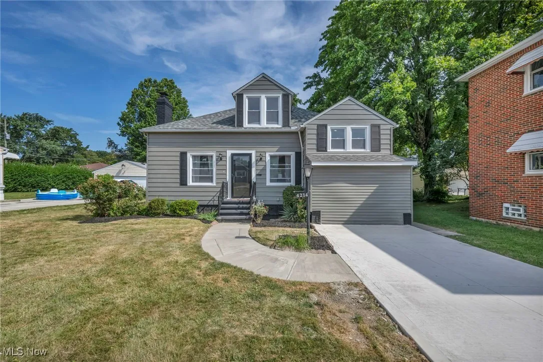 Front of house, featuring a new roof, new driveway, and new windows.
