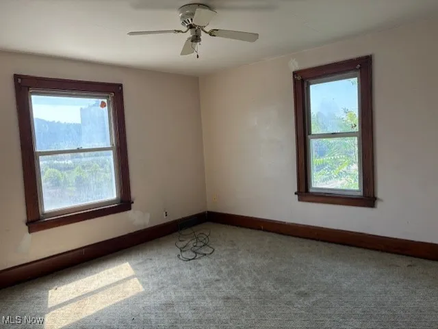 Bed room featuring healthy amount of natural light, carpet, and ceiling fan