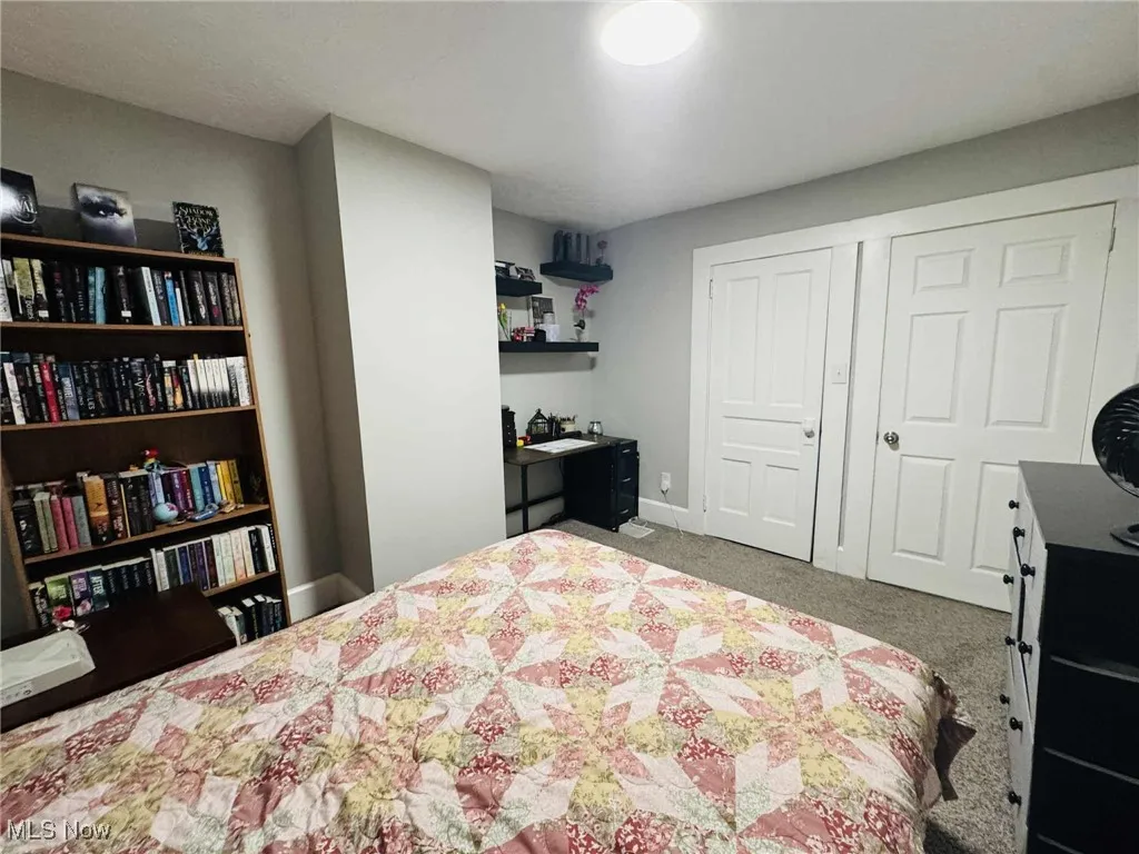 Bedroom featuring light colored carpet and a closet