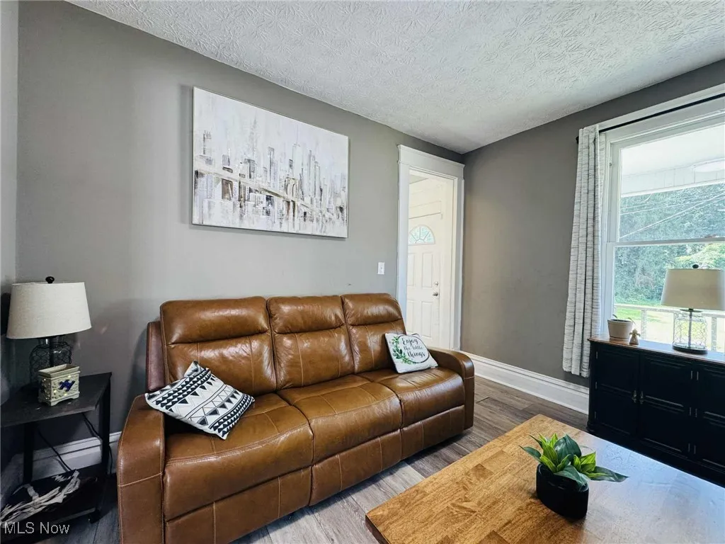 Living room with wood finished floors and a textured ceiling