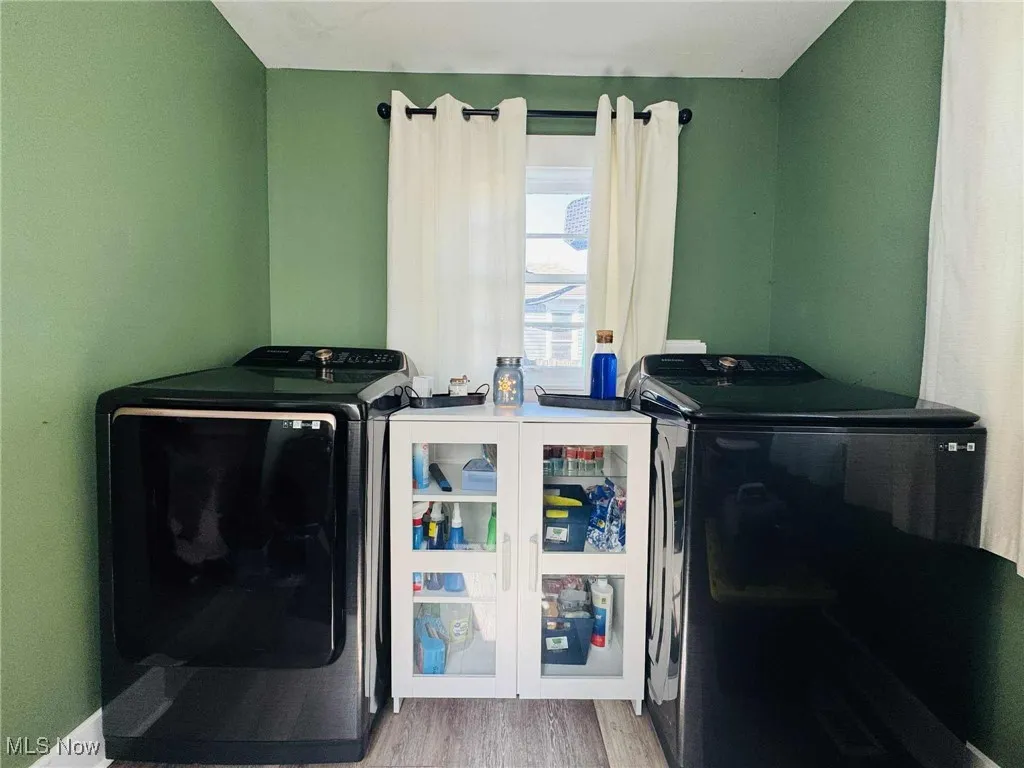 Laundry room featuring independent washer and dryer and light wood finished floors