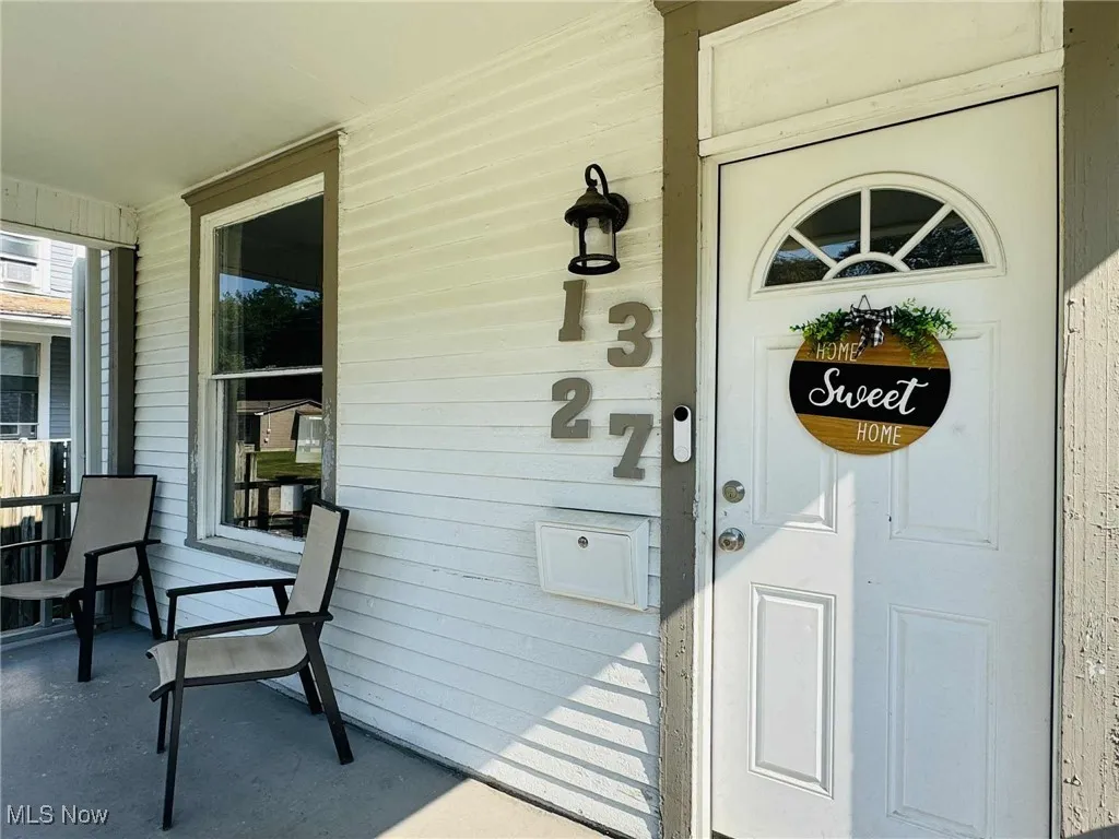 View of exterior entry with a porch