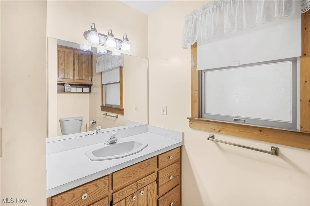 Half bath with vanity and toilet