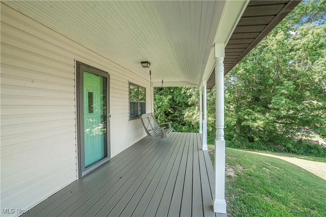 Wooden porch with a yard