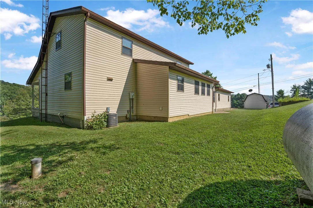View of property exterior with a lawn