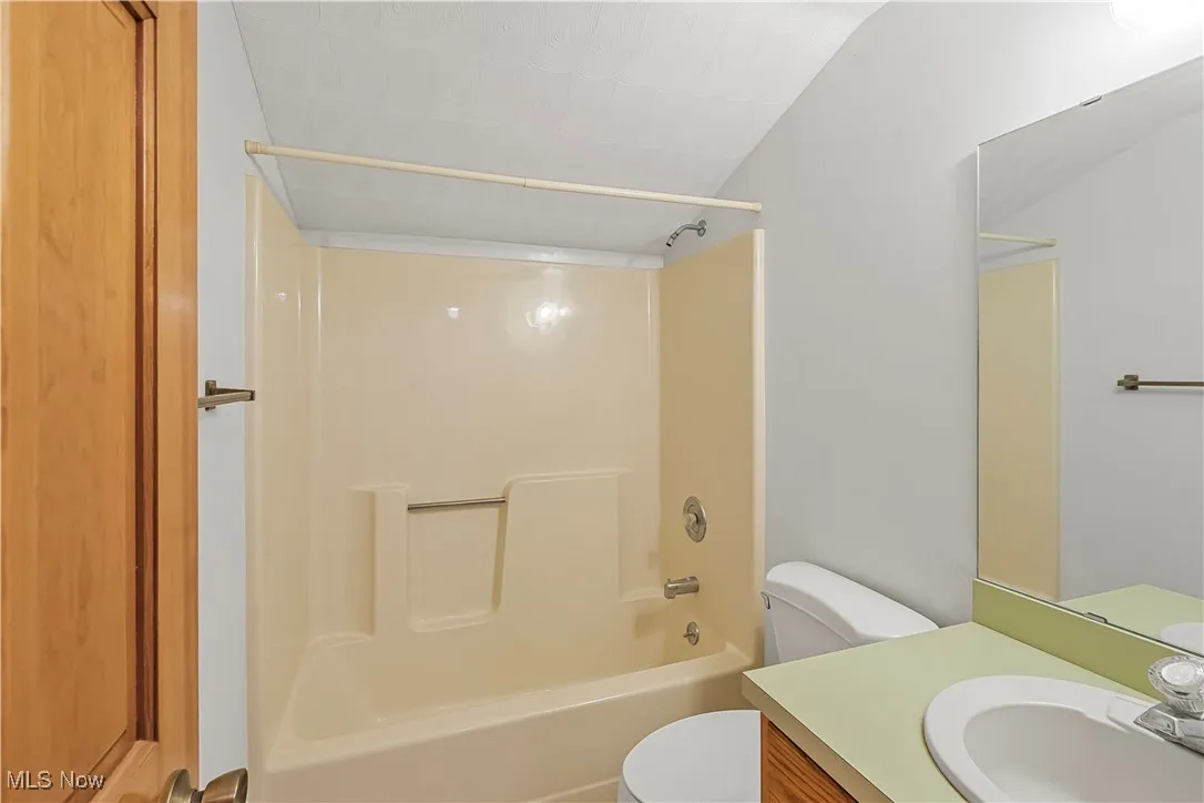 Full bath featuring tub / shower combination and vanity