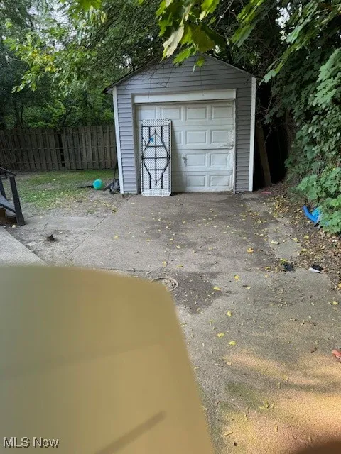 Detached garage featuring asphalt driveway